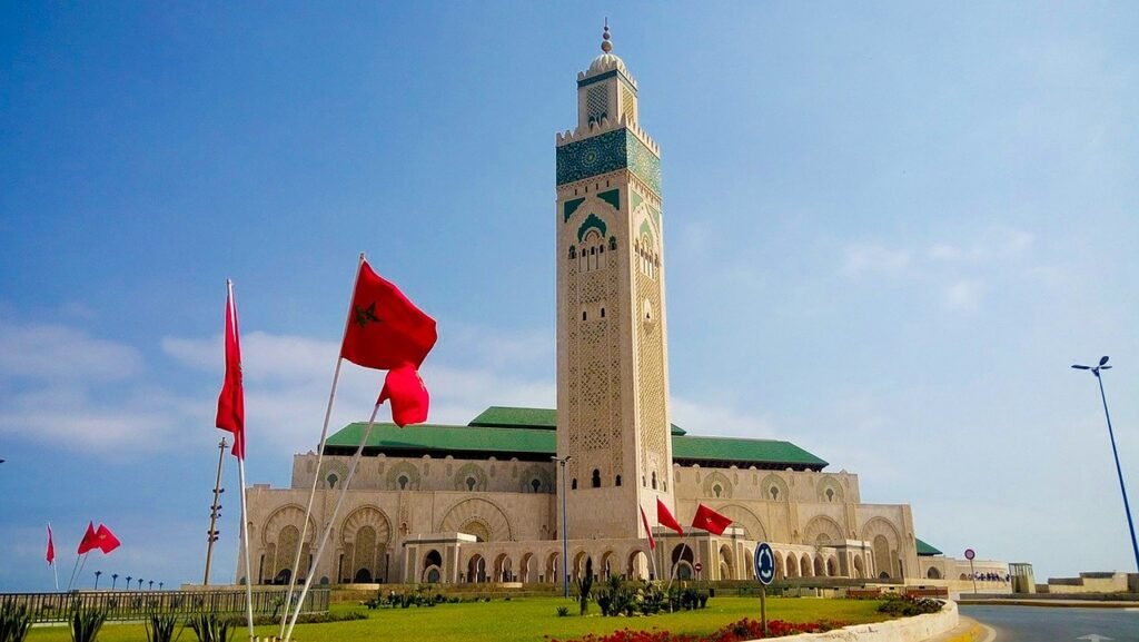 Hassan II Mosque minaret and Moroccan flags in Casablanca