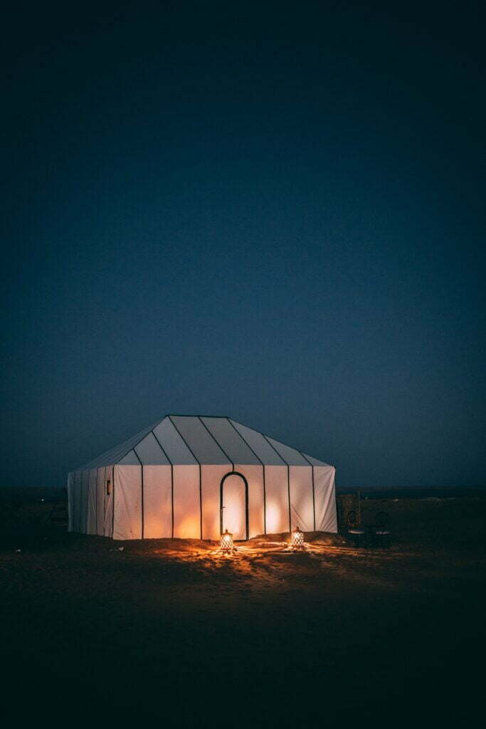 Desert camp tent glowing at night in the Sahara
