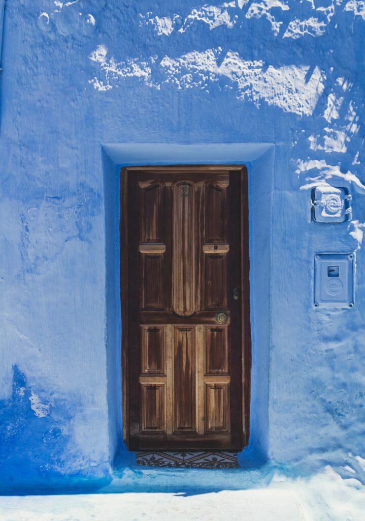 Blue wall and wooden window in Chefchaouen
