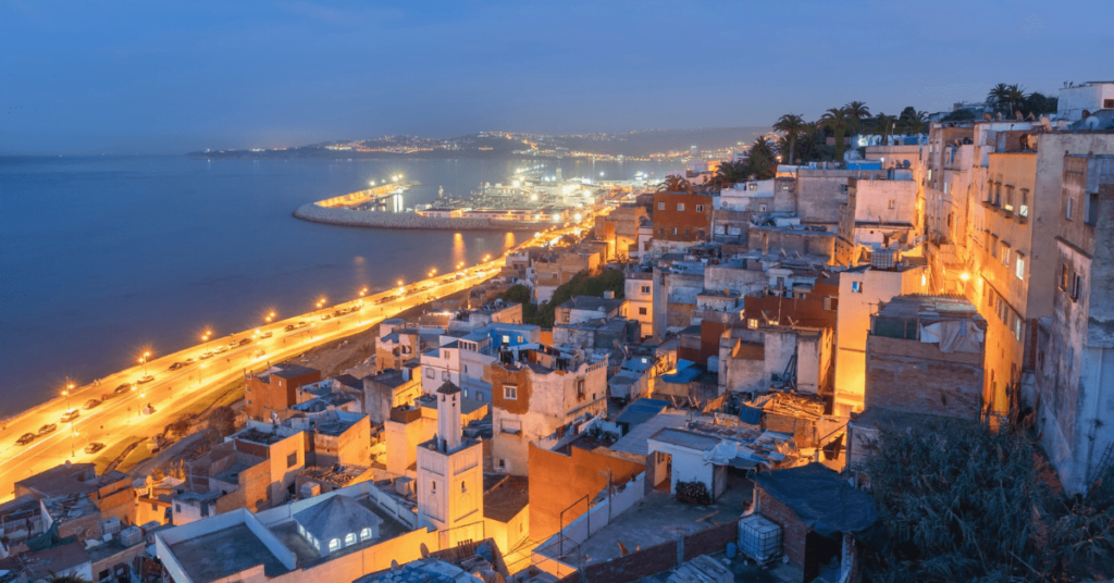 Coastal Moroccan city lit up at dusk