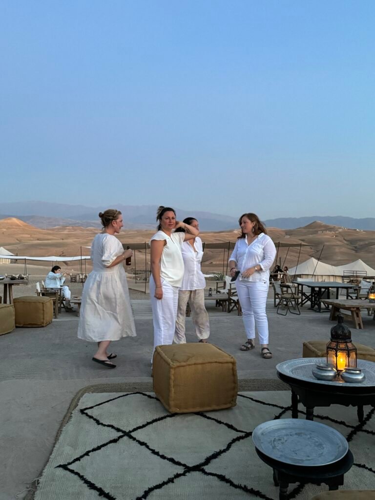 Travelers in white at a desert camp in Agafay