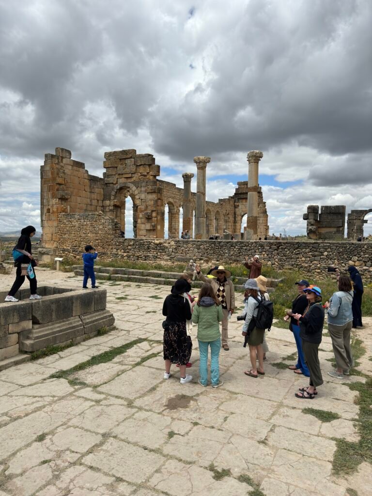 Travelers exploring the Roman ruins of Volubilis