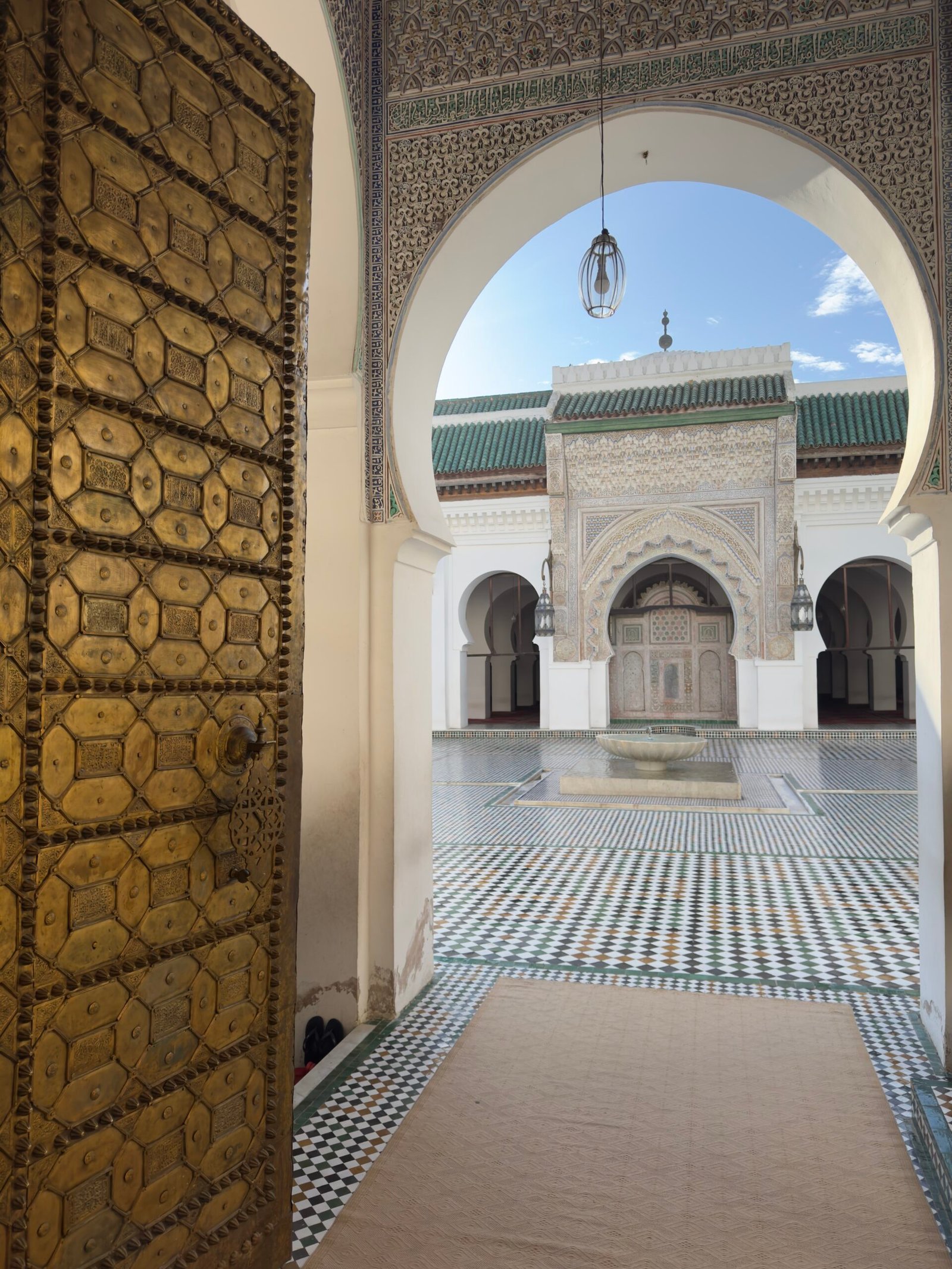 Golden doorway framing the Kairaouine Mosque courtyard in Fez