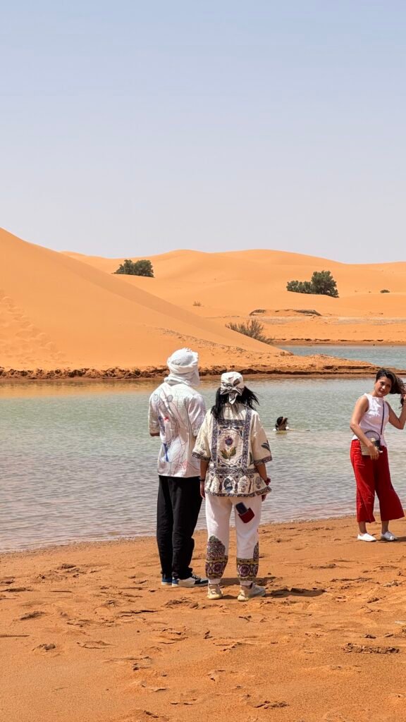 Travelers walking on the Sahara sand dunes