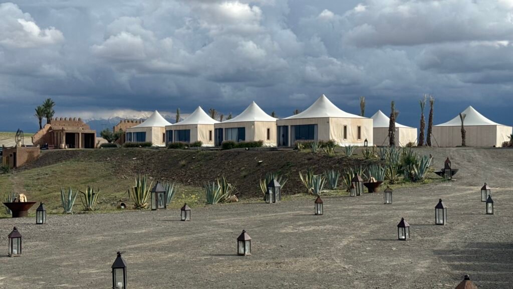 Luxury desert camp tents under a stormy sky
