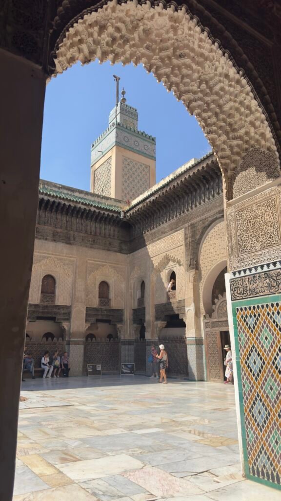 Courtyard of a Fez medersa with carved cedar and zellige