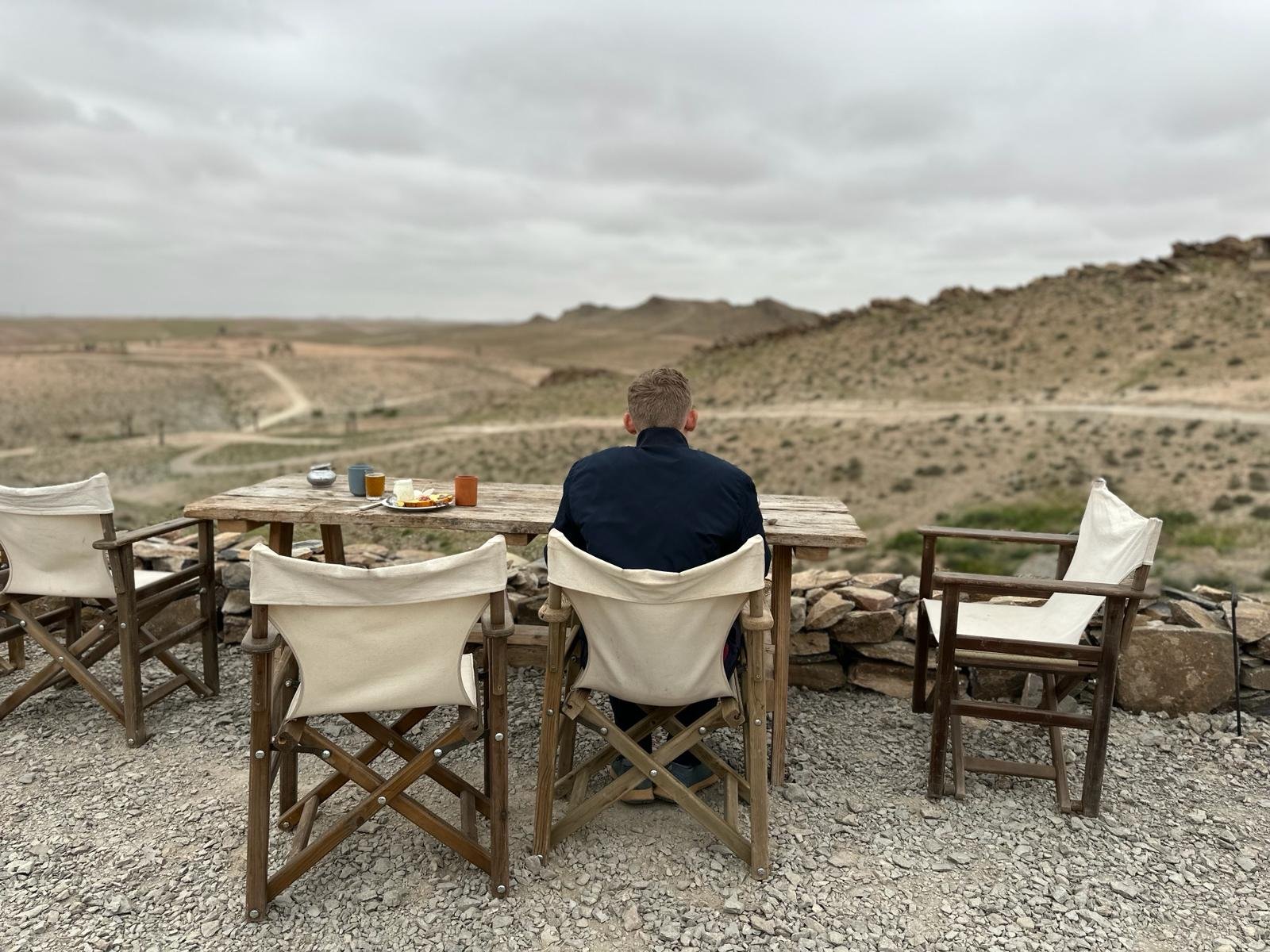Traveler overlooking a desert valley landscape